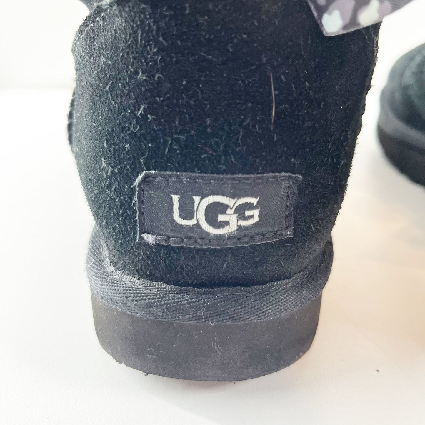 UGG Mini Bailey Sherpa Ankle Boots Leopard Bow Tie Back Black 8